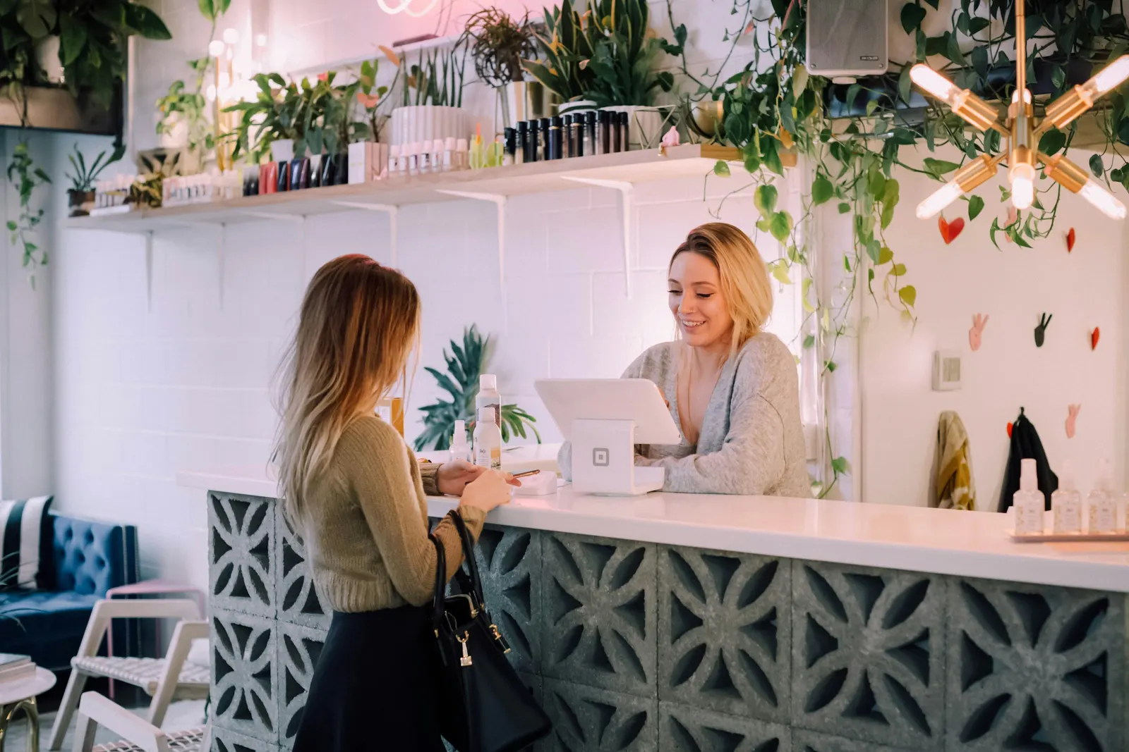 A customer being served at the counter of a small local shop
